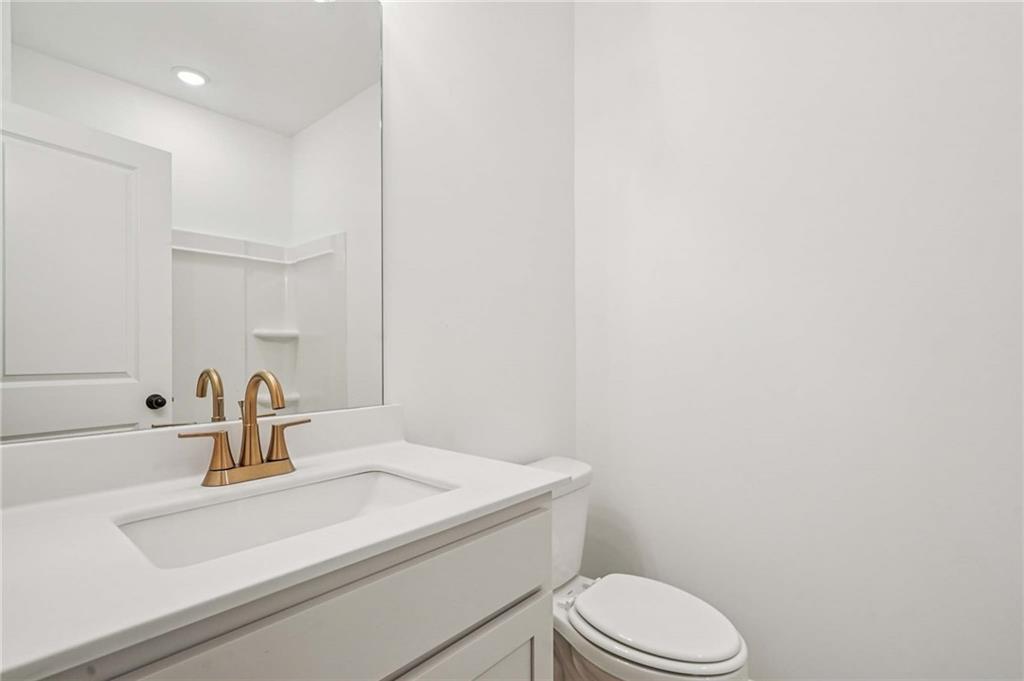 240 Silverleaf Trail Bethlehem, GA 30620 - Photo 13 of 39 a bathroom with a sink a toilet and mirror