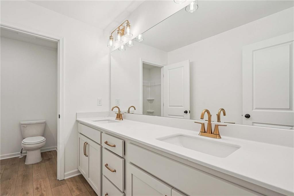 240 Silverleaf Trail Bethlehem, GA 30620 - Photo 16 of 39 a bathroom with a sink a toilet and a mirror