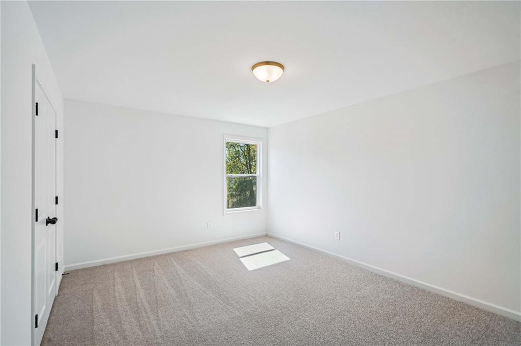 240 Silverleaf Trail Bethlehem, GA 30620 - Photo 19 of 39 an empty room with a empty space and a window
