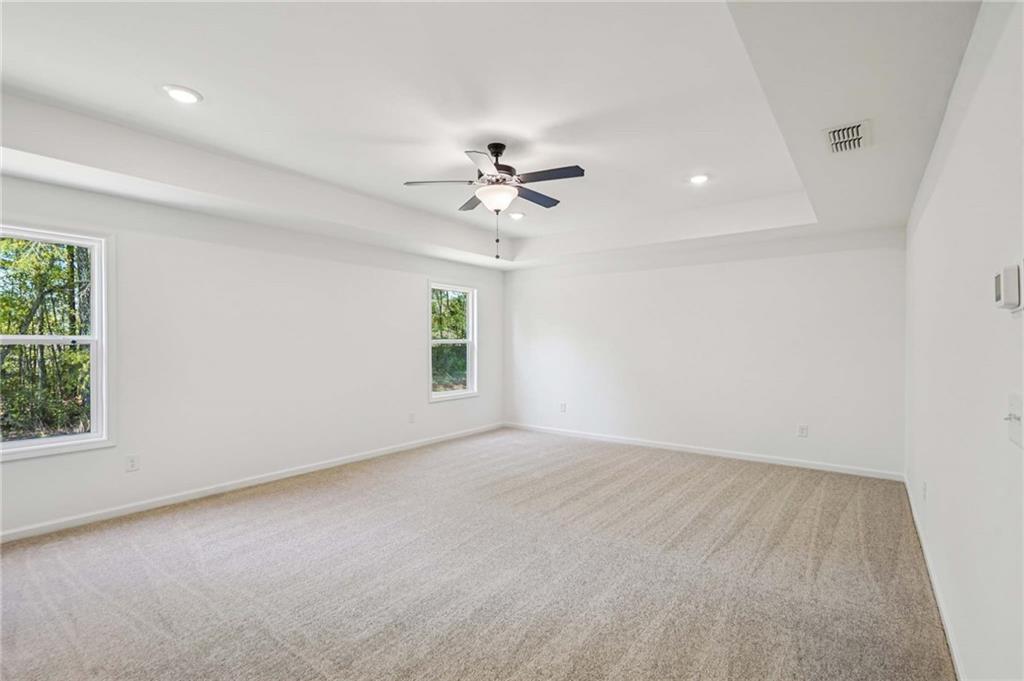 240 Silverleaf Trail Bethlehem, GA 30620 - Photo 21 of 39 an empty room with windows and chandelier fan