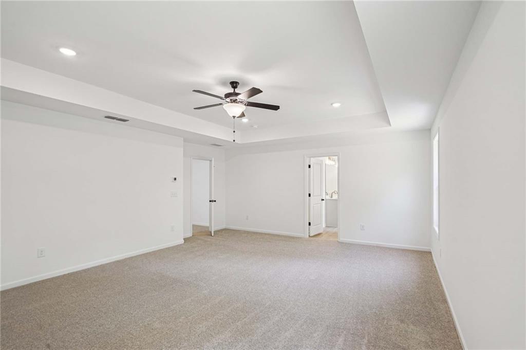 240 Silverleaf Trail Bethlehem, GA 30620 - Photo 22 of 39 an empty room with a ceiling fan and a window