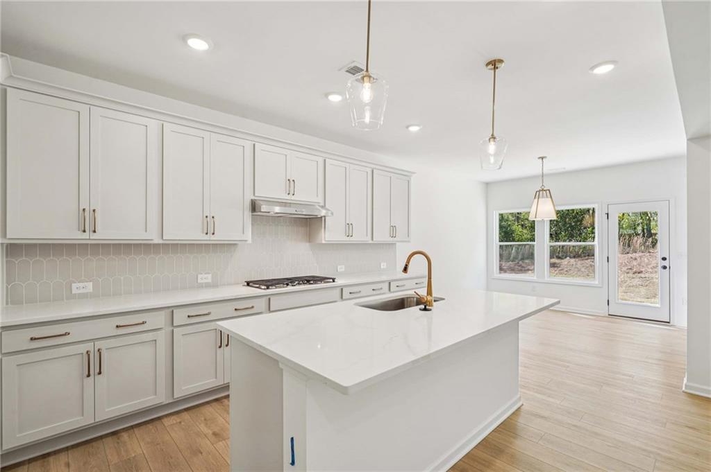 240 Silverleaf Trail Bethlehem, GA 30620 - Photo 6 of 39 a kitchen with a sink window and cabinets