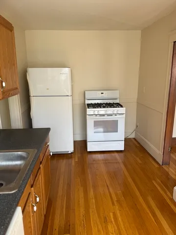 a kitchen with a wooden floor and a stove