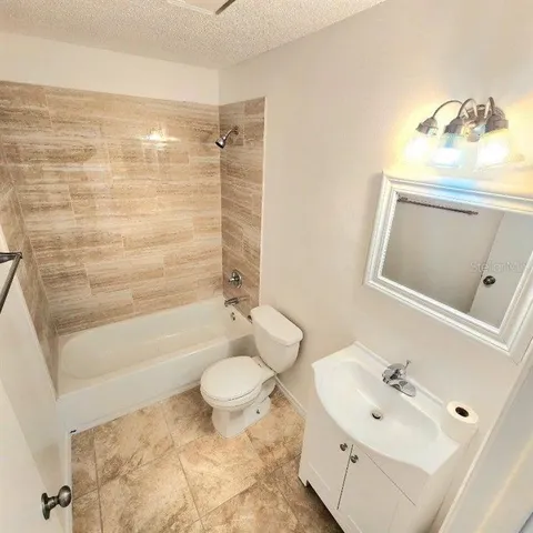 a bathroom with a sink mirror toilet and bathtub