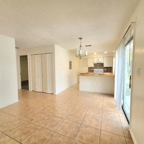 a view of a kitchen with a sink and a refrigerator