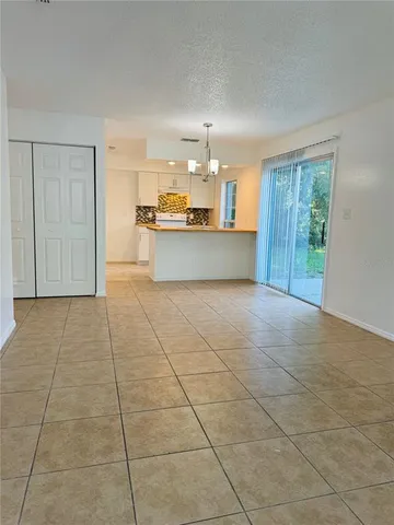 a view of kitchen with granite countertop cabinets