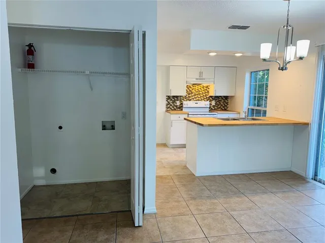 a kitchen with stainless steel appliances granite countertop a sink and a refrigerator