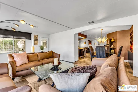 a kitchen with stainless steel appliances kitchen island granite countertop a table and chairs