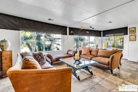 a living room with furniture and large window