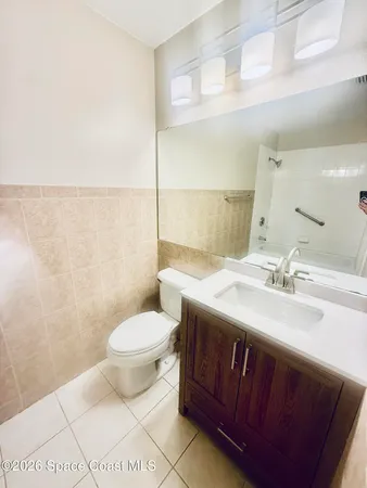 a bathroom with a sink a toilet and mirror