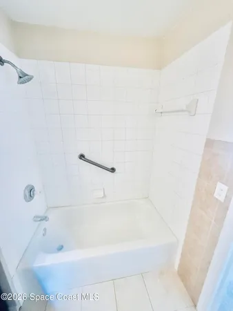 a bath tub sitting next to a white sink and vanity