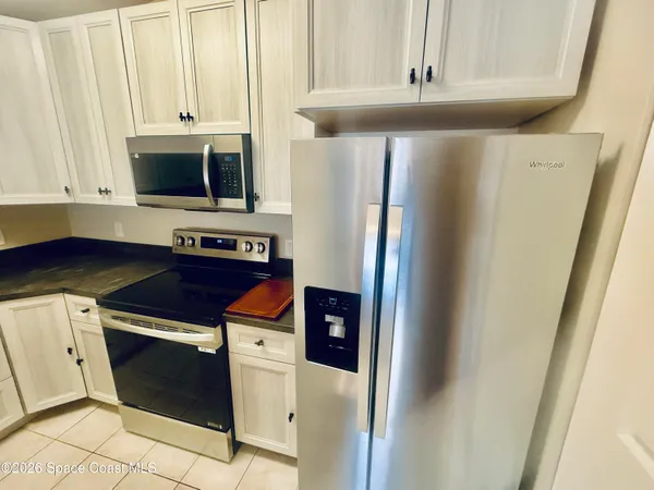 a kitchen with stainless steel appliances a refrigerator and a stove top oven
