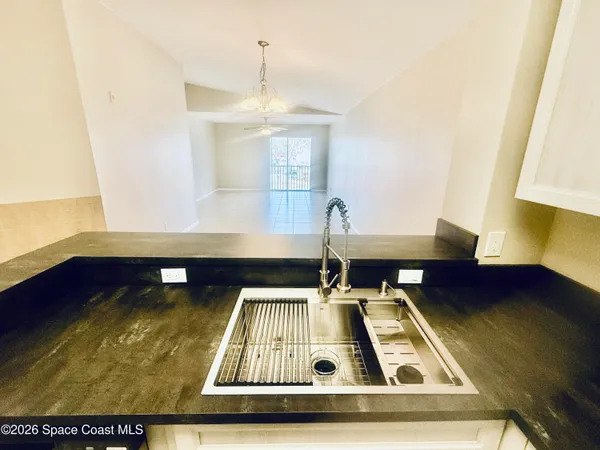 a view of a living room with furniture and rug
