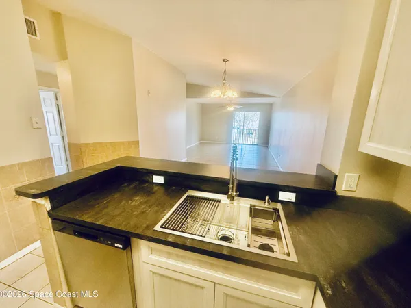 a view of a kitchen with a sink and a window