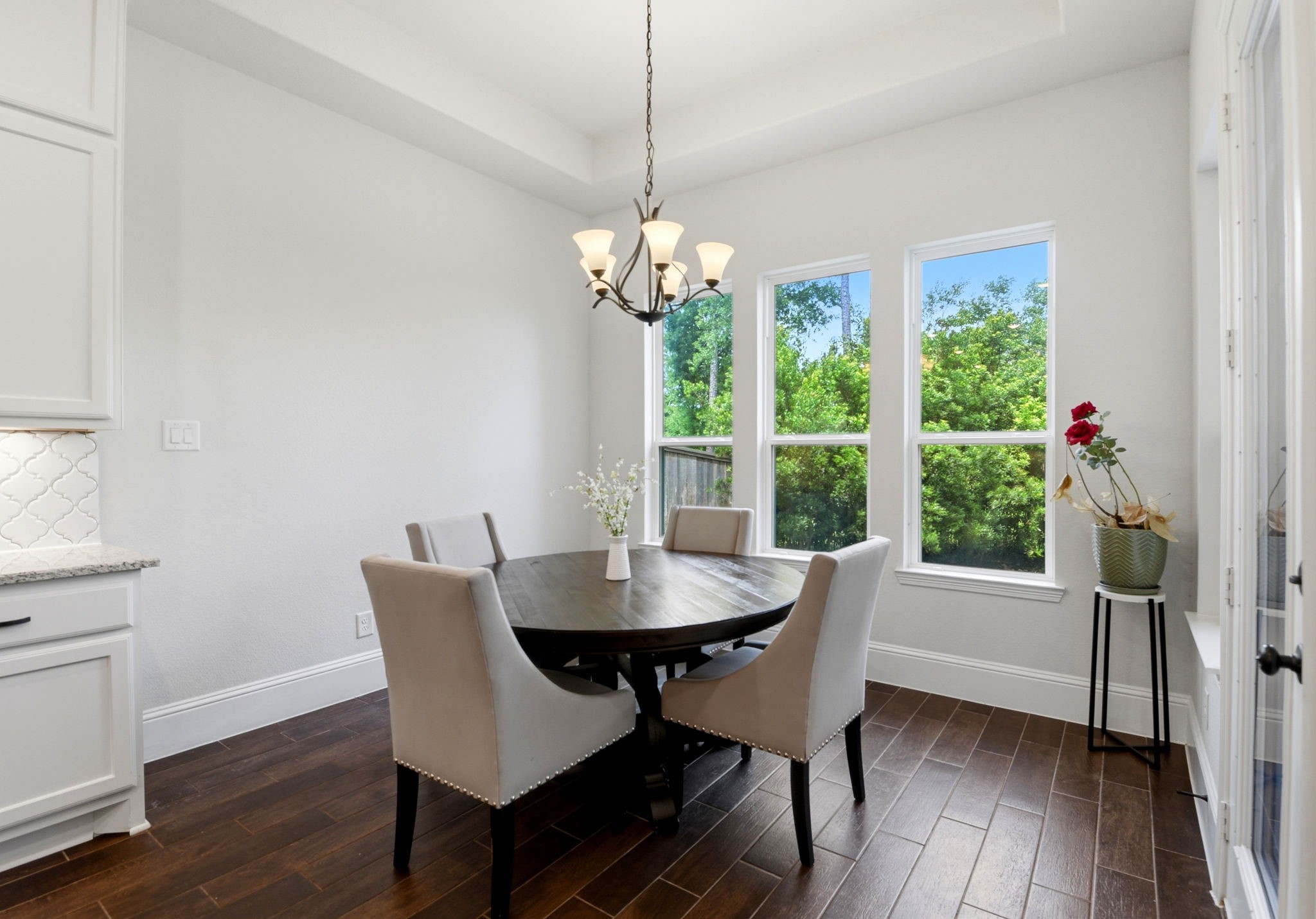 10062 South Goshawk Trail Conroe, TX 77385 - Photo 14 of 43 a dining room with furniture a chandelier and wooden floor