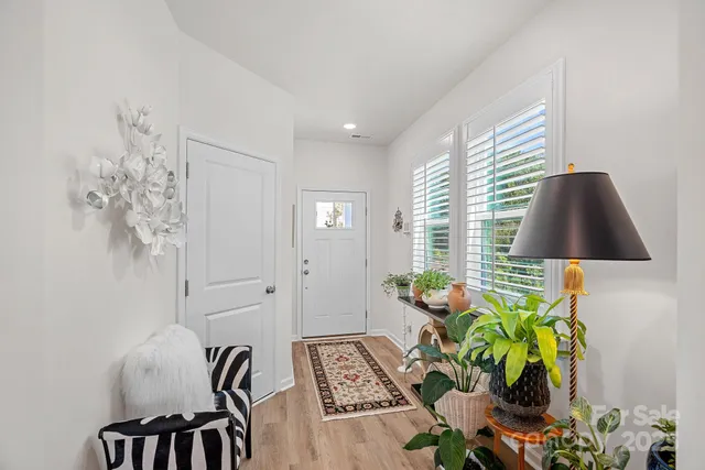 a view of living room with furniture and a potted plant