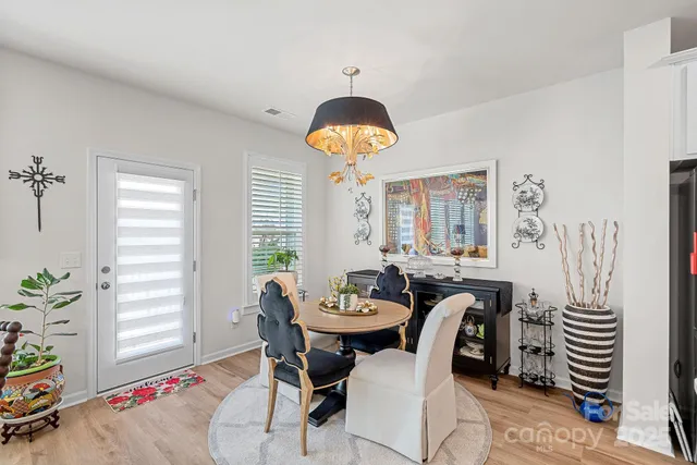 a view of a dining room with furniture and a window