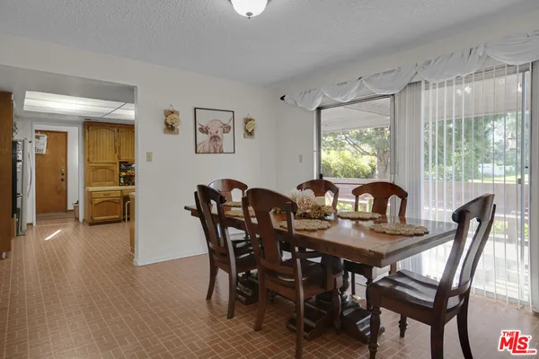 a view of a dining room with furniture and window