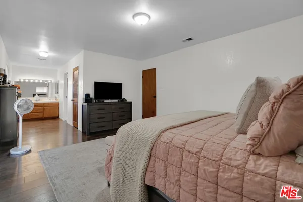 a bedroom with a bed and a television