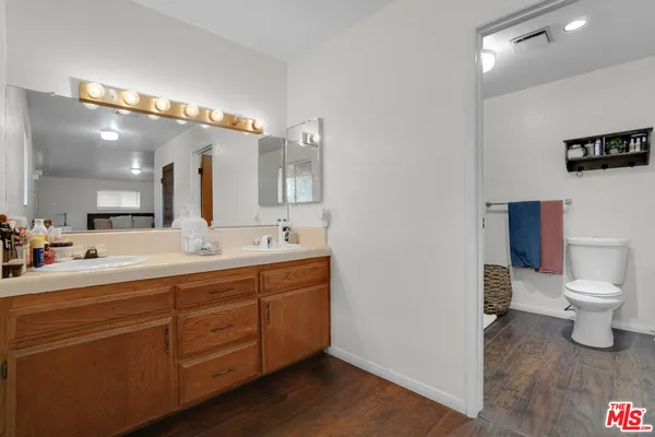 a bathroom with a toilet a sink and a shower