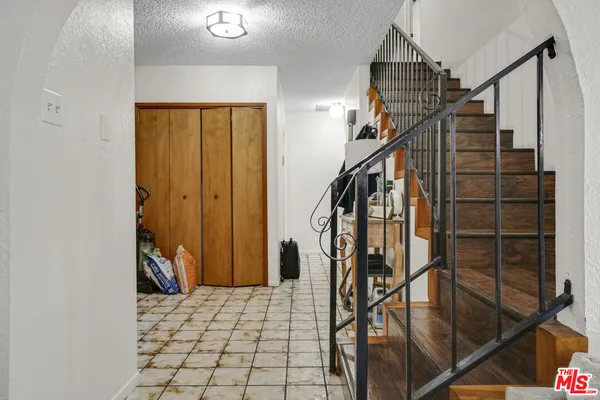 a view of staircase with white walls and stairs
