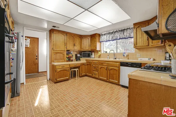 a kitchen with a sink cabinets and window