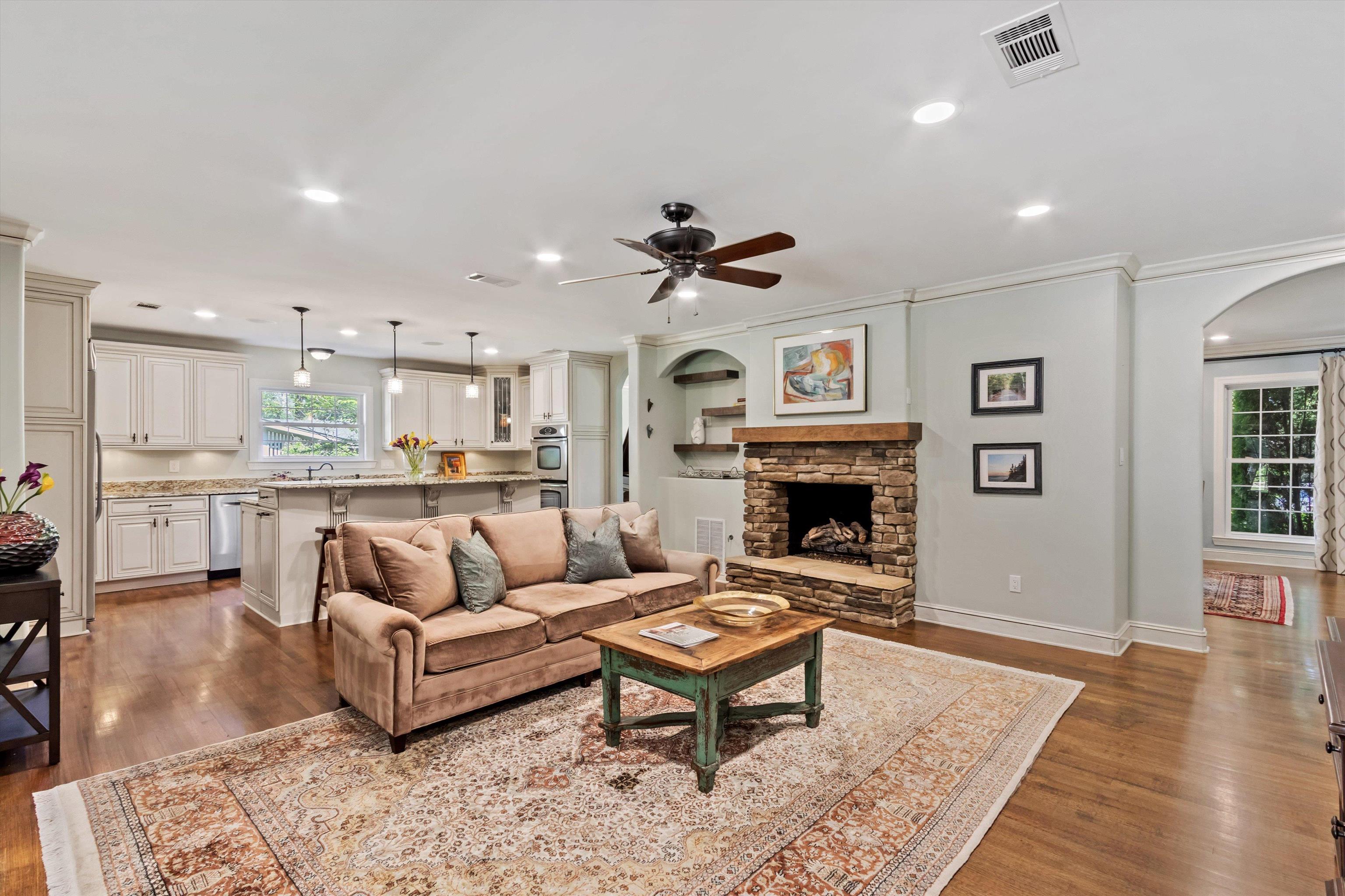 5302 South Angela Road Memphis, TN 38120 - Photo 12 of 40 Living area featuring a stone fireplace with a wood mantle, wood-finish flooring, and recessed lighting