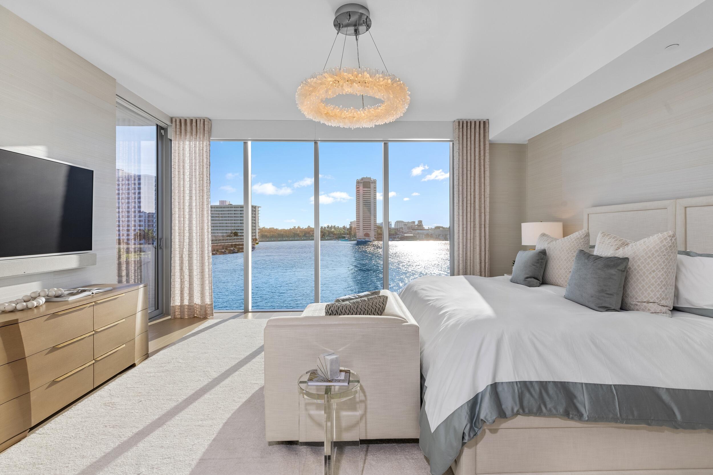 725 South Ocean Boulevard, Unit 402 Boca Raton, FL 33432 - Photo 14 of 41 a bedroom with a bed and a flat screen tv