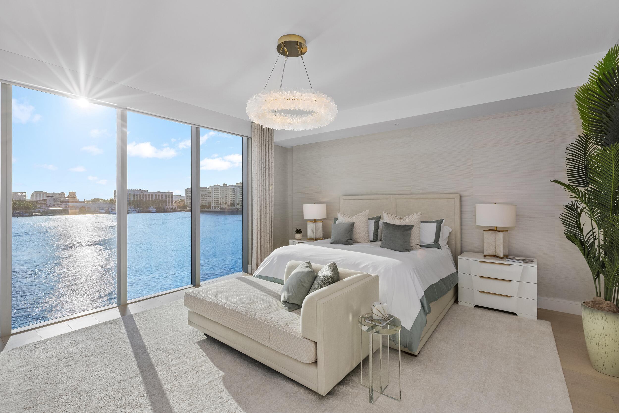 725 South Ocean Boulevard, Unit 402 Boca Raton, FL 33432 - Photo 15 of 41 a bedroom with bed and large windows