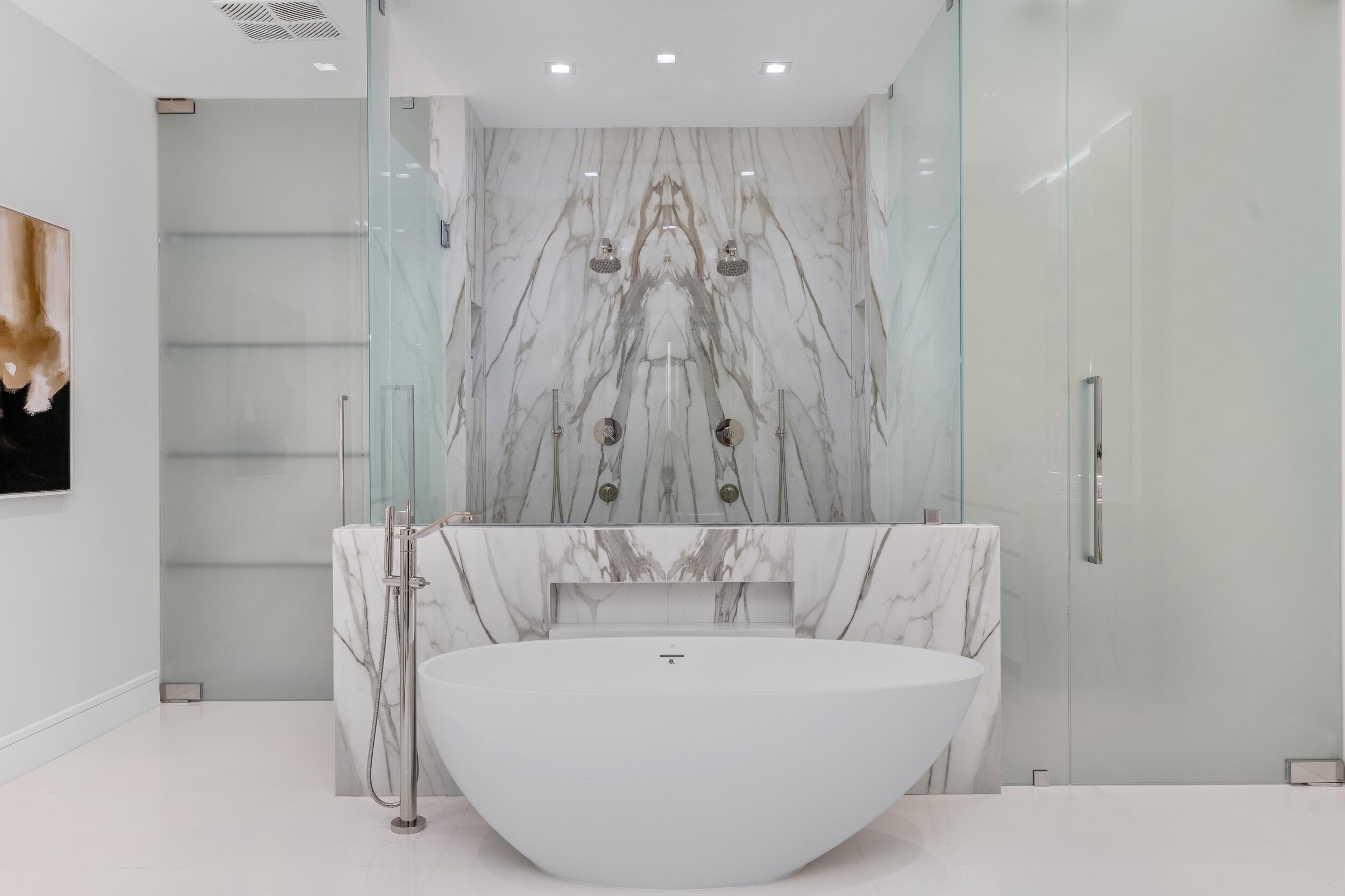 725 South Ocean Boulevard, Unit 402 Boca Raton, FL 33432 - Photo 18 of 41 a white bath tub sitting in a bathroom