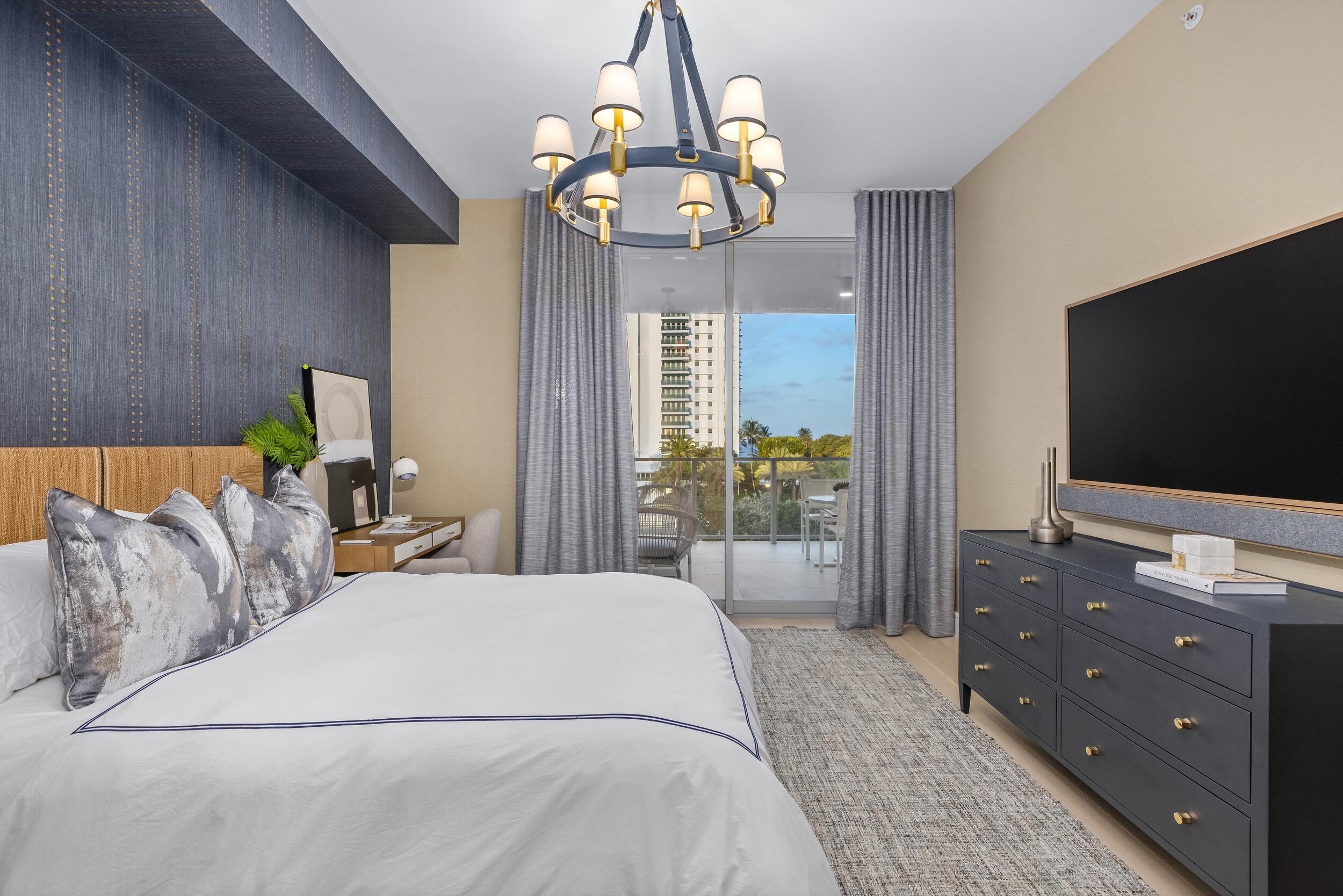 725 South Ocean Boulevard, Unit 402 Boca Raton, FL 33432 - Photo 20 of 41 a bedroom with a bed and a flat screen tv