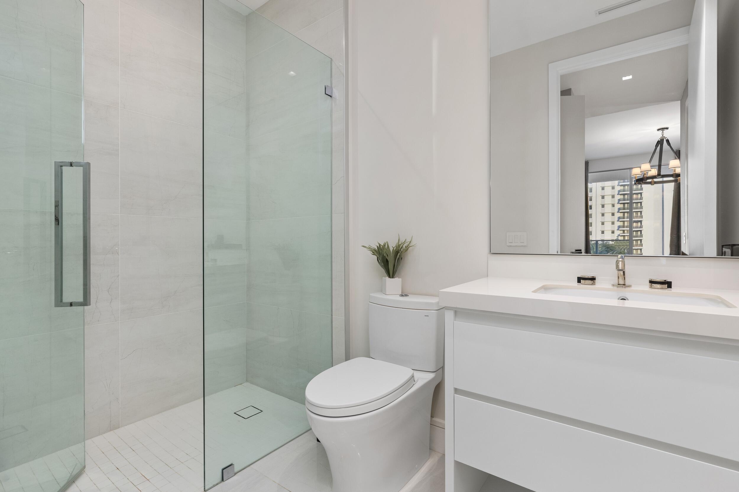 725 South Ocean Boulevard, Unit 402 Boca Raton, FL 33432 - Photo 21 of 41 a bathroom with a sink a toilet and shower