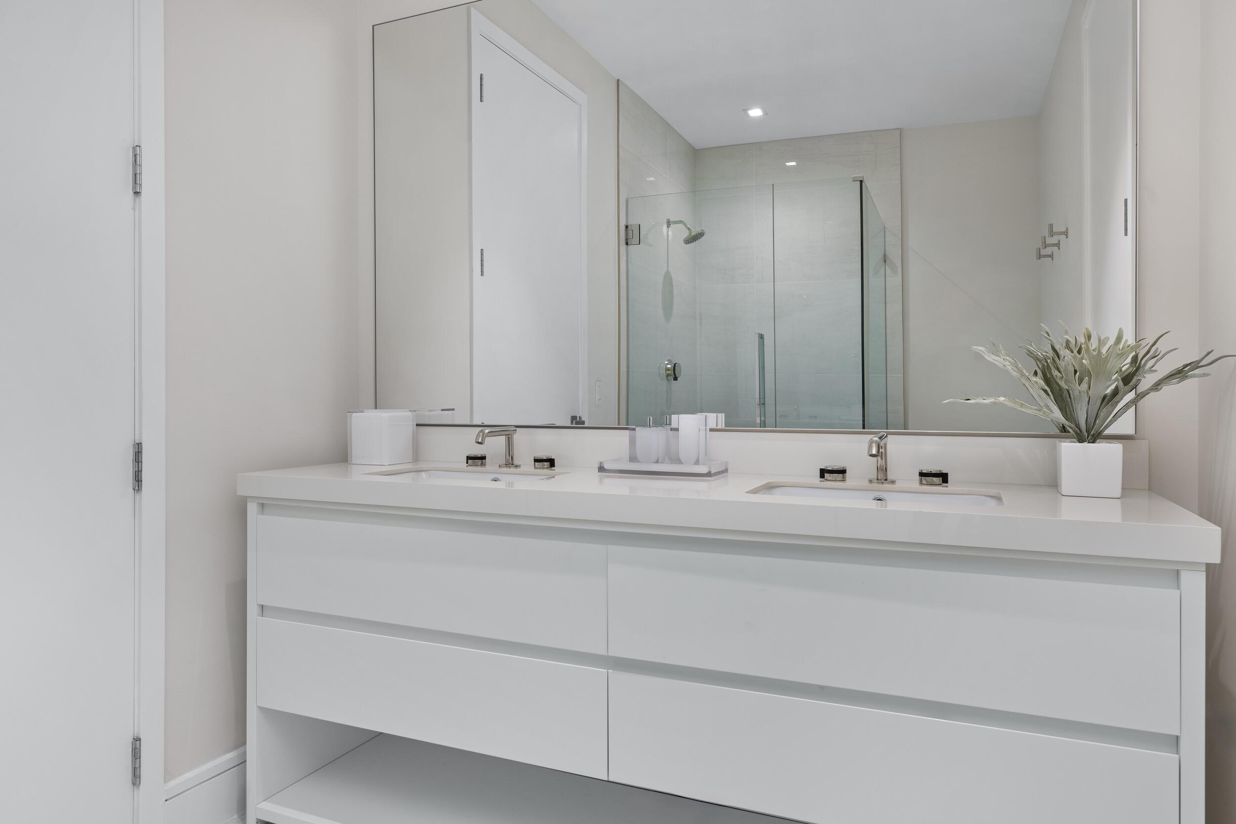 725 South Ocean Boulevard, Unit 402 Boca Raton, FL 33432 - Photo 23 of 41 a bathroom with a sink and a mirror