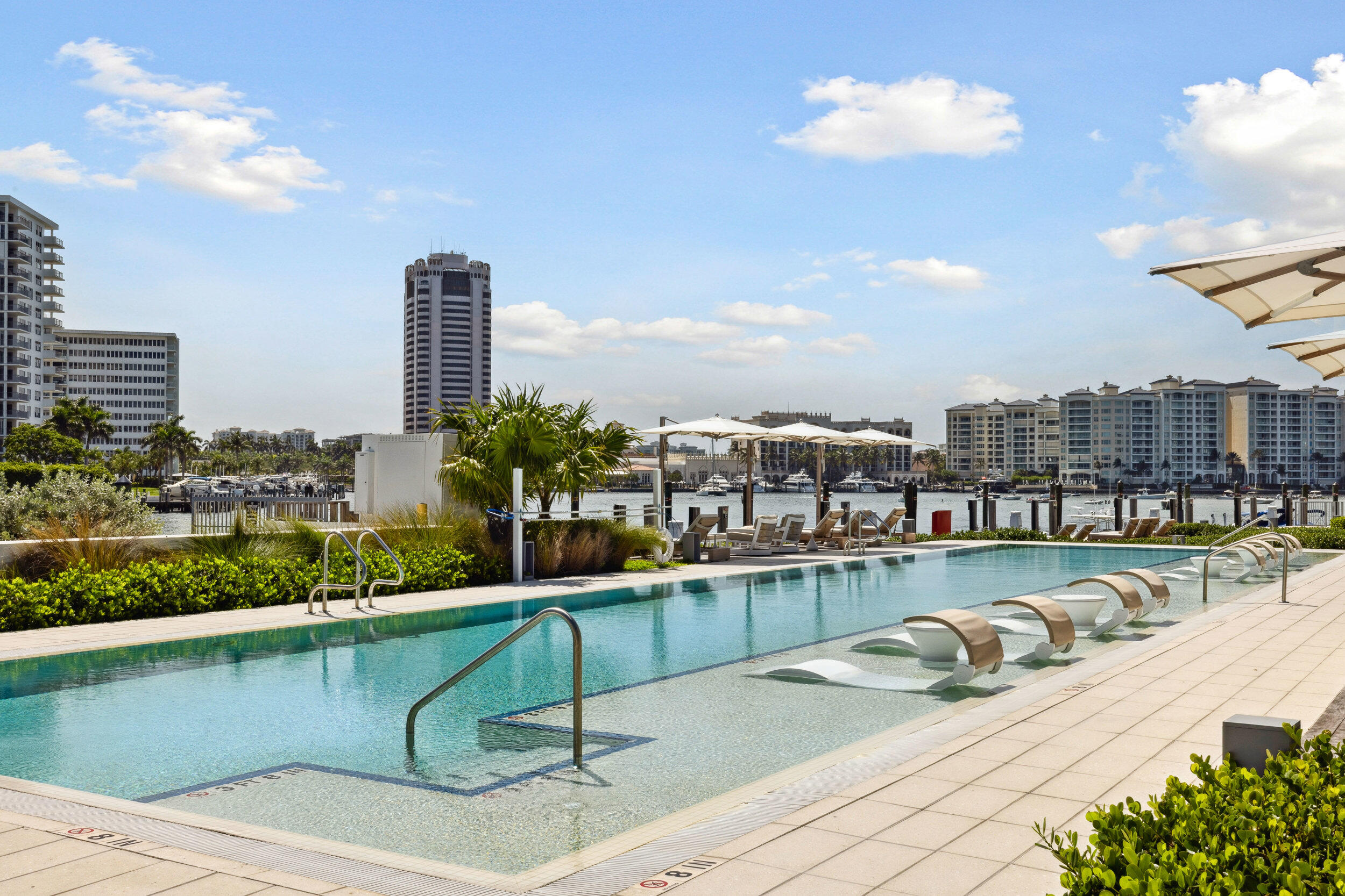 725 South Ocean Boulevard, Unit 402 Boca Raton, FL 33432 - Photo 36 of 41 a view of a swimming pool with a lounge chair