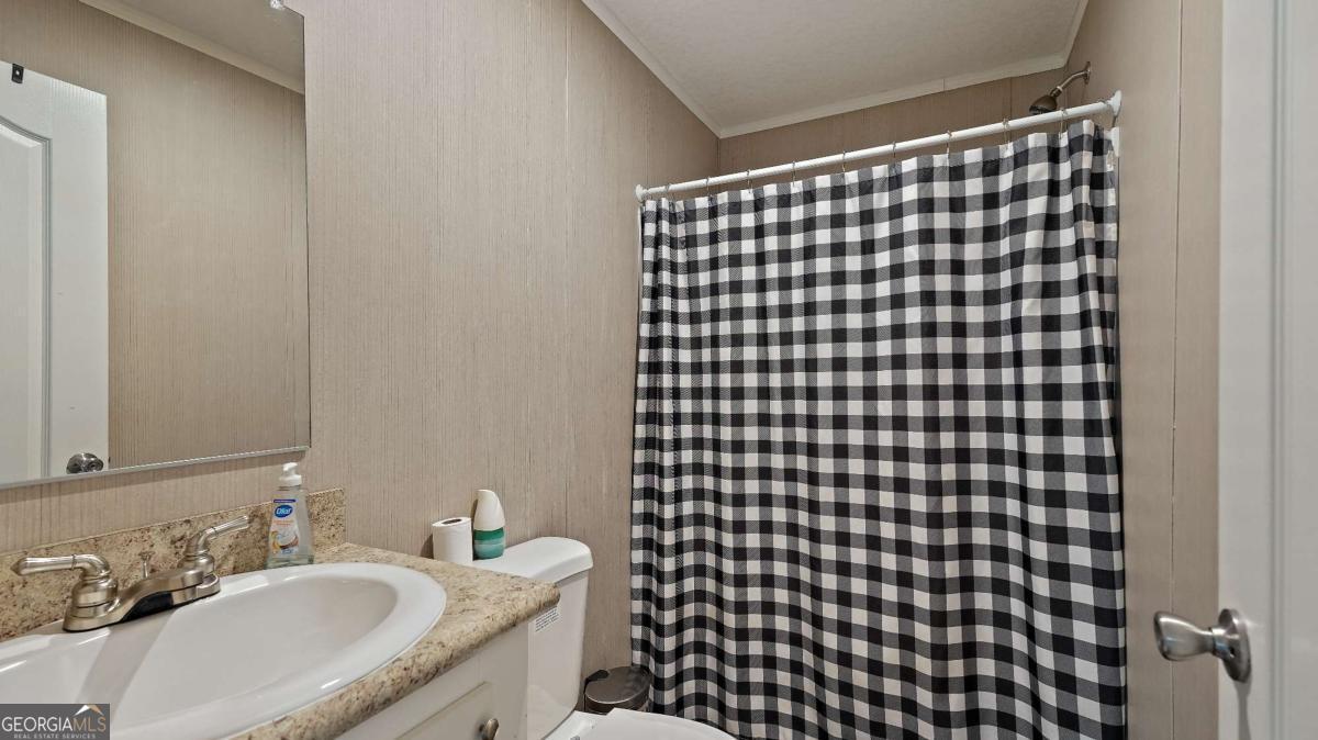 64 Sierra Road Jesup, GA 31545 - Photo 22 of 22 a bathroom with a sink toilet and shower