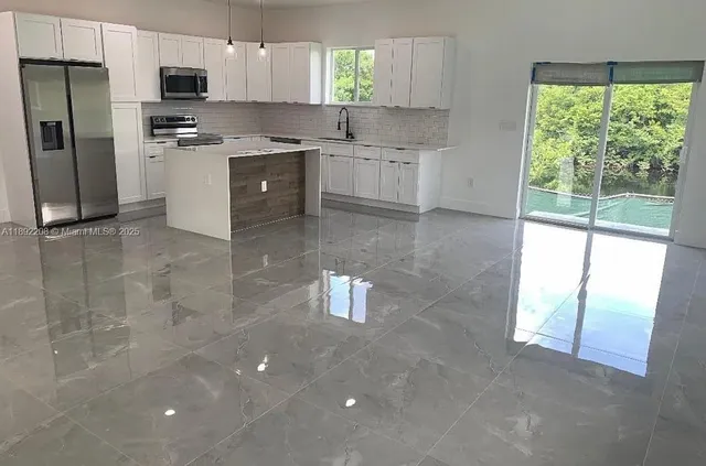 a bathroom with a granite countertop toilet a sink a mirror and shower