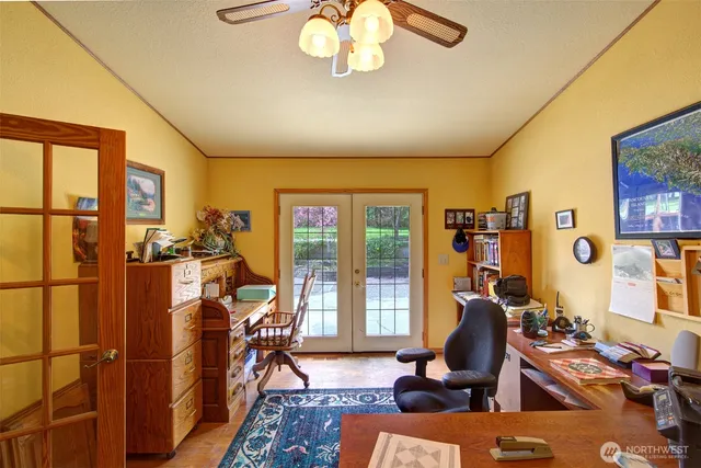 a view of a livingroom with workspace and a window