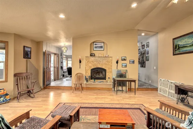a living room with furniture a fireplace and a flat screen tv