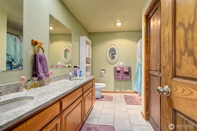 a bathroom with a sink a mirror and a shower