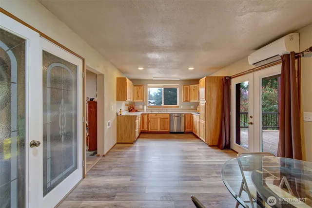 a view of a kitchen with wooden floor and a kitchen