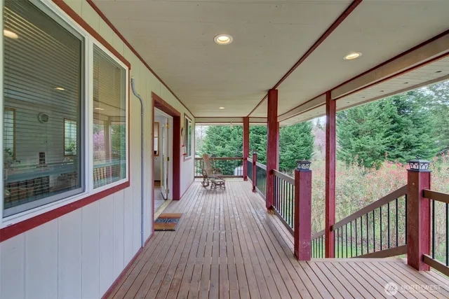 a view of a balcony with floor to ceiling windows with wooden floor