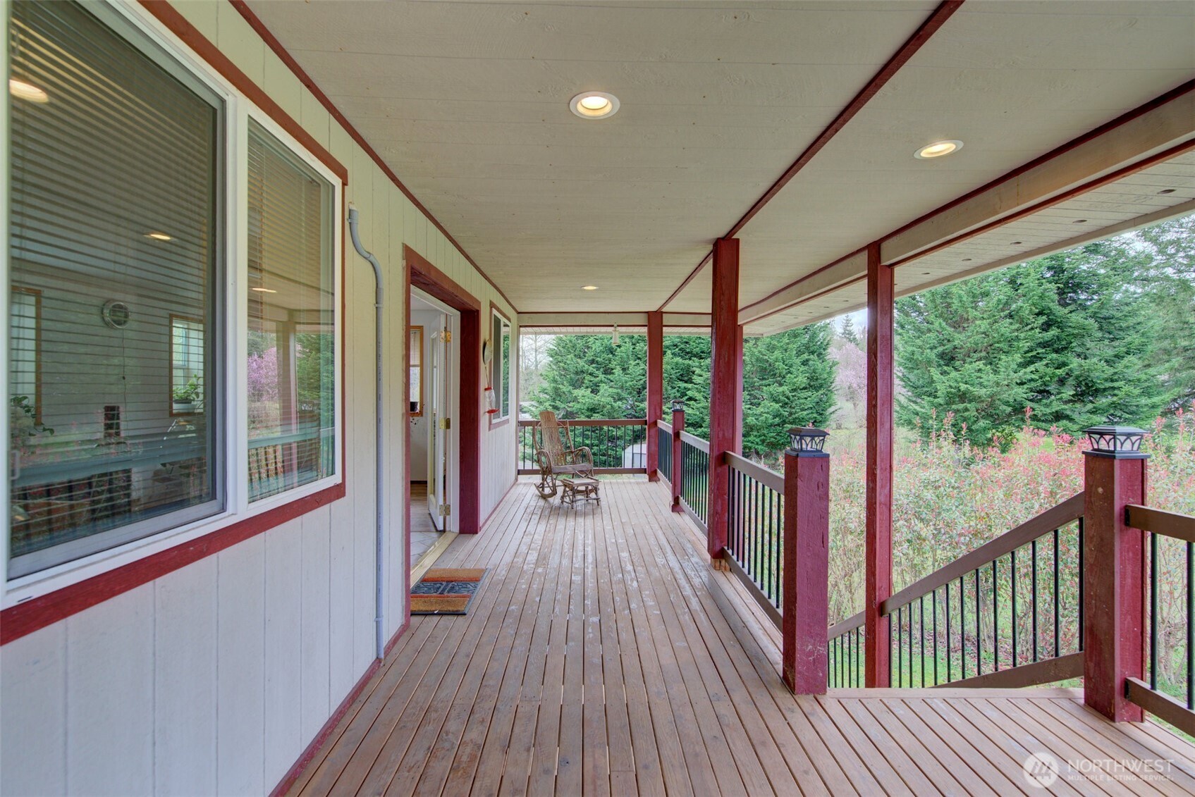 15714 Forty Five Road Arlington, WA 98223 - Photo 27 of 40 a view of a balcony with floor to ceiling windows with wooden floor