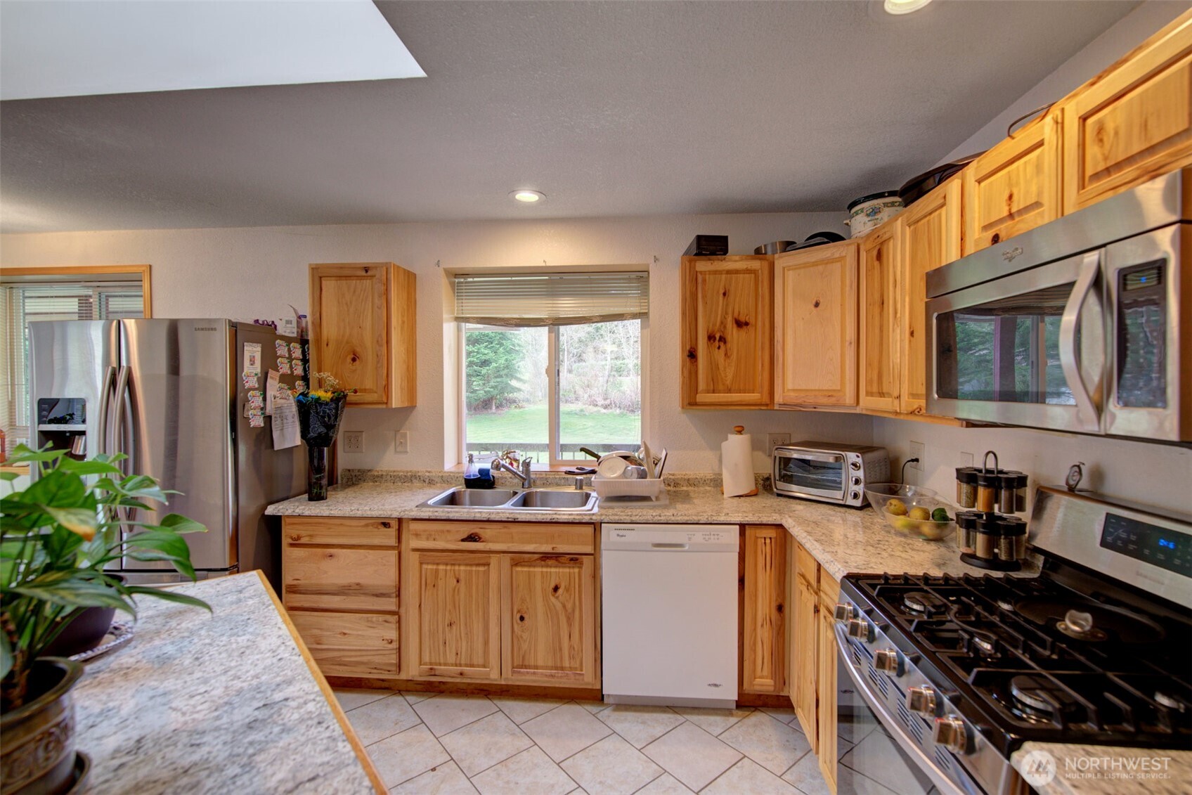 15714 Forty Five Road Arlington, WA 98223 - Photo 30 of 40 a kitchen with a sink stove and cabinets
