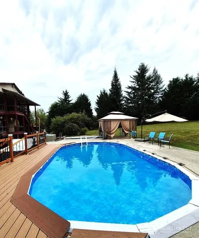 a view of a swimming pool with an outdoor seating