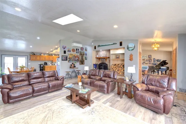 a living room with furniture and a large mirror with potted plants