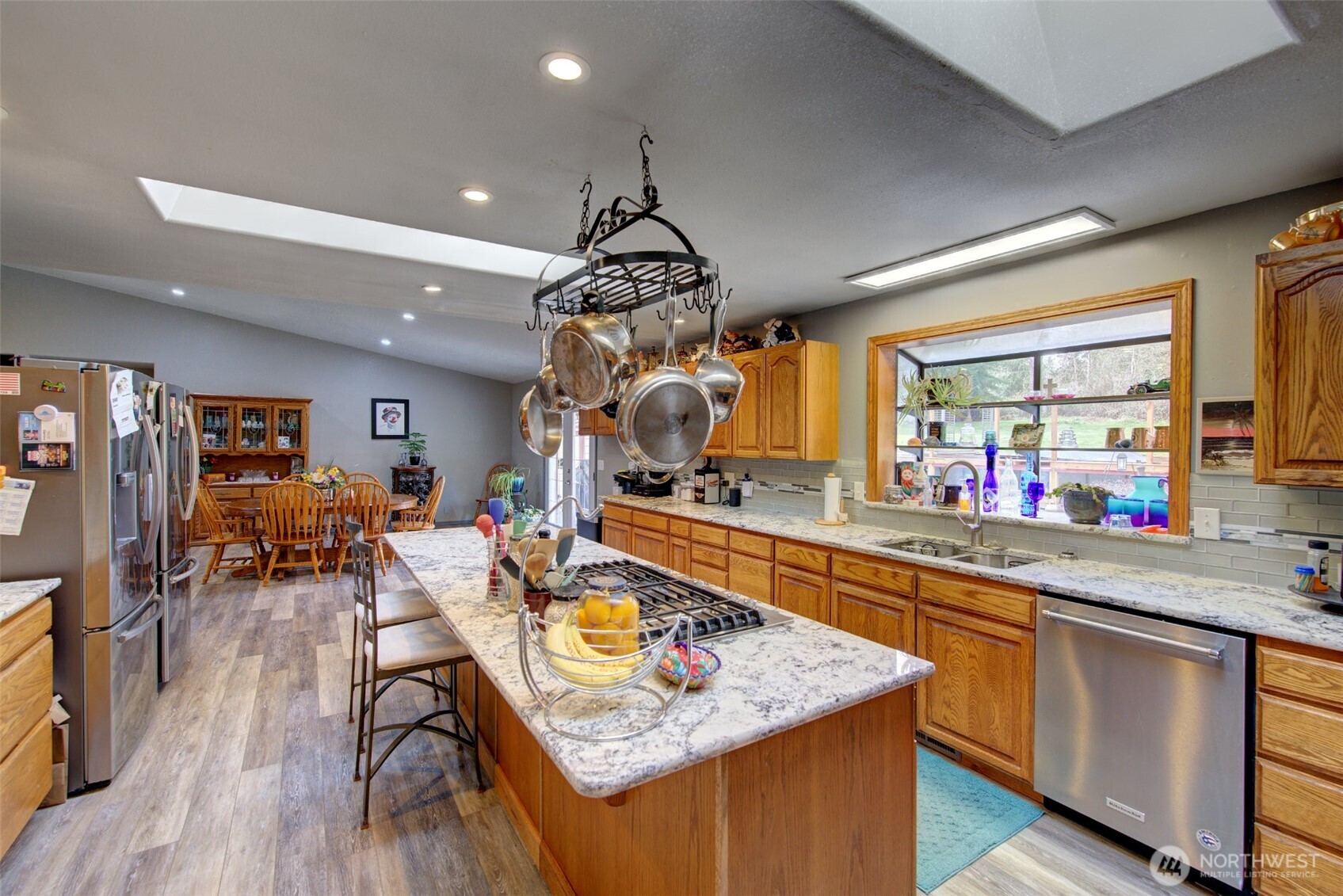 15714 Forty Five Road Arlington, WA 98223 - Photo 10 of 40 a kitchen with a table chairs stove and wooden floor