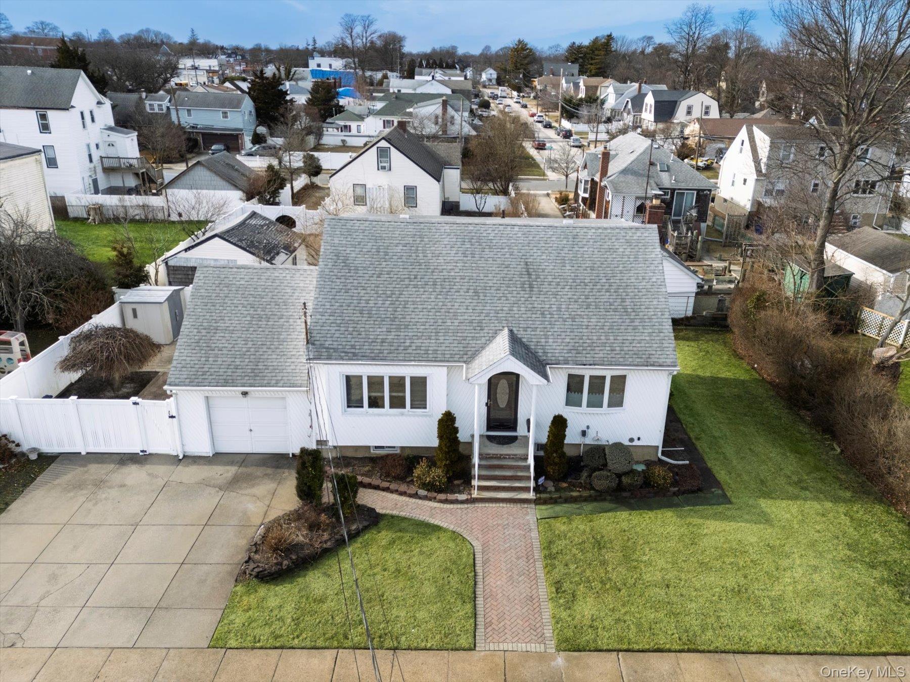 an aerial view of a house with swimming pool and sitting area