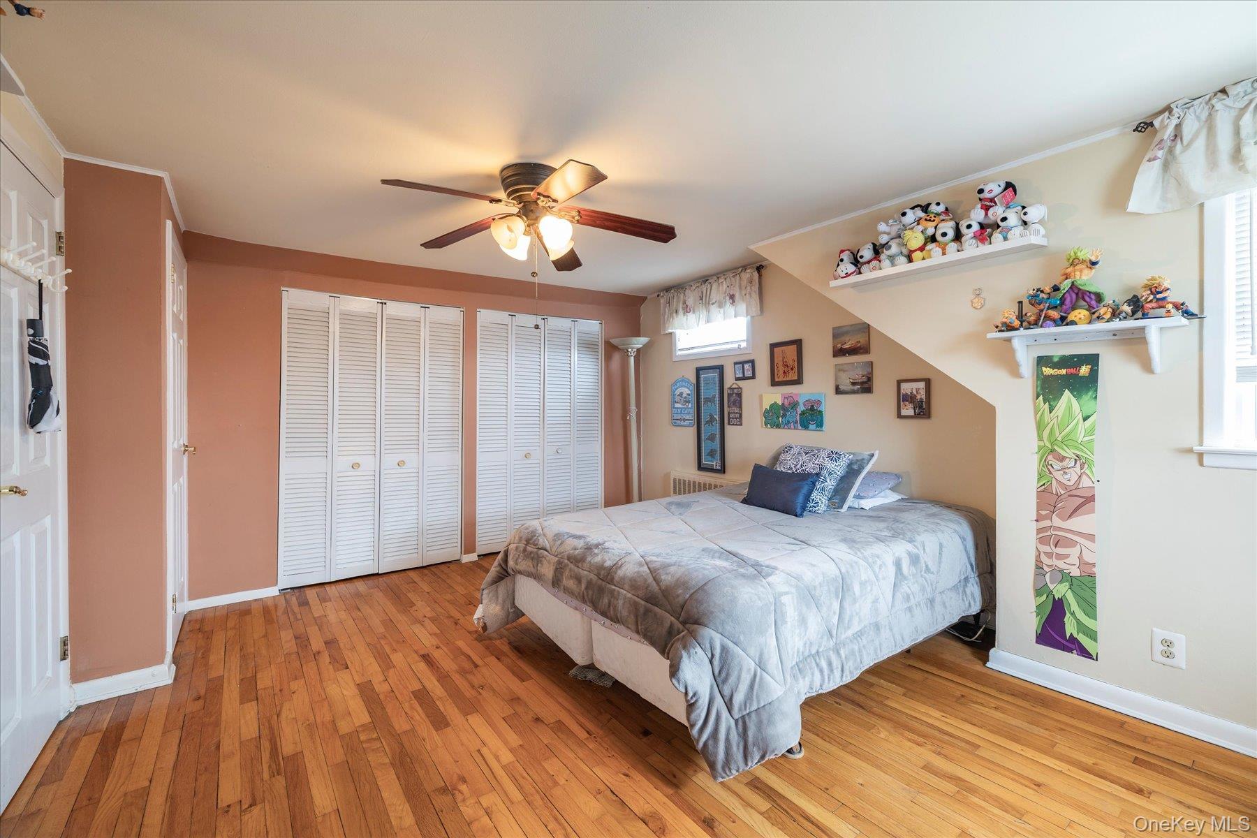 158 Roosevelt Avenue Freeport, NY 11520 - Photo 14 of 30 a bedroom with a large bed and a chandelier