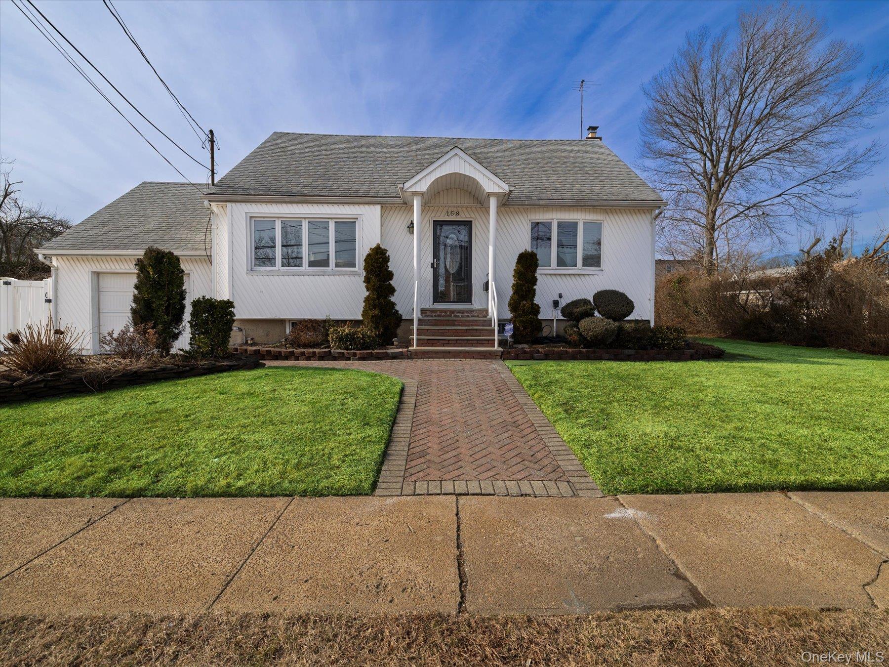 158 Roosevelt Avenue Freeport, NY 11520 - Photo 15 of 30 a front view of a house with a yard