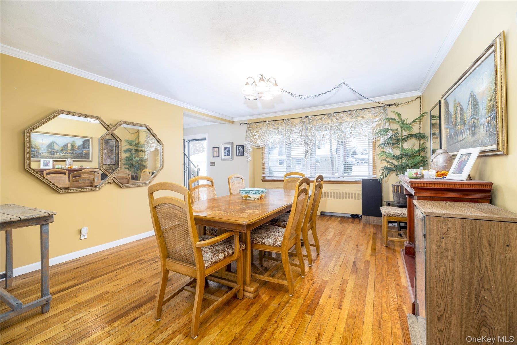 158 Roosevelt Avenue Freeport, NY 11520 - Photo 5 of 30 a view of a dining room with furniture a chandelier and wooden floor